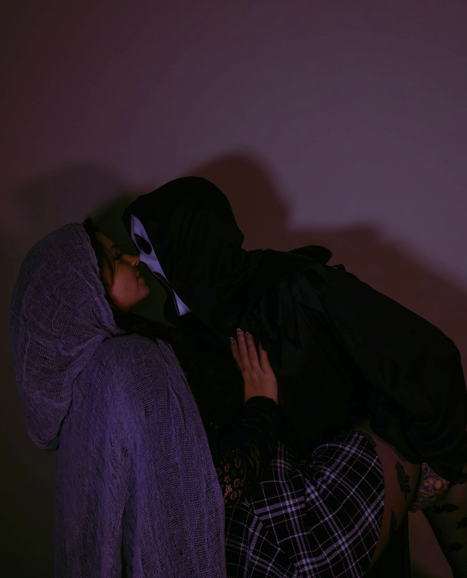 Themed Halloween couple shoot in moody purple light